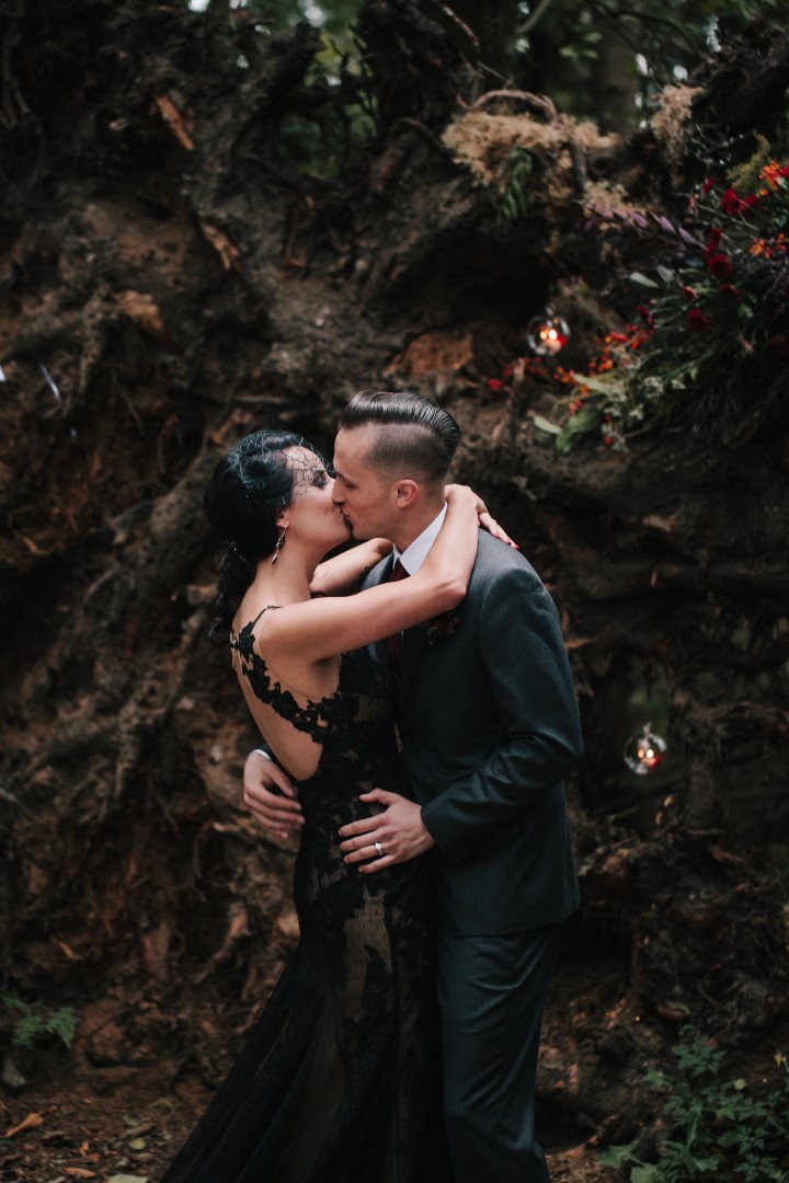 Newlywed Kiss in Forest Ceremony Gothic Dark Elegance West Coast Weddings Magazine