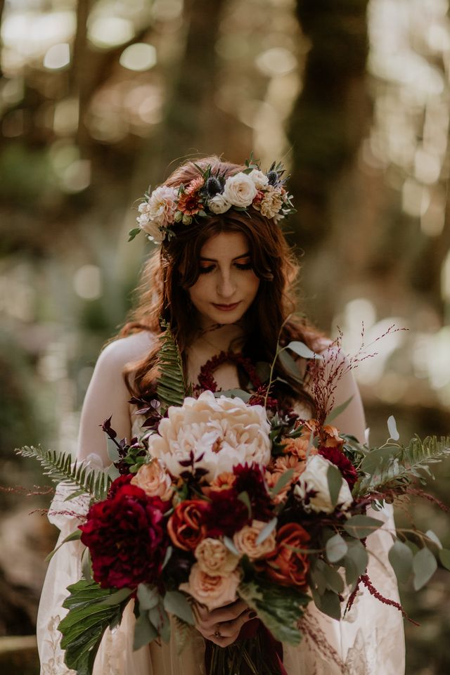 bride in forest with large bouquet of ferns, roses and peony by West Coast Floral Design