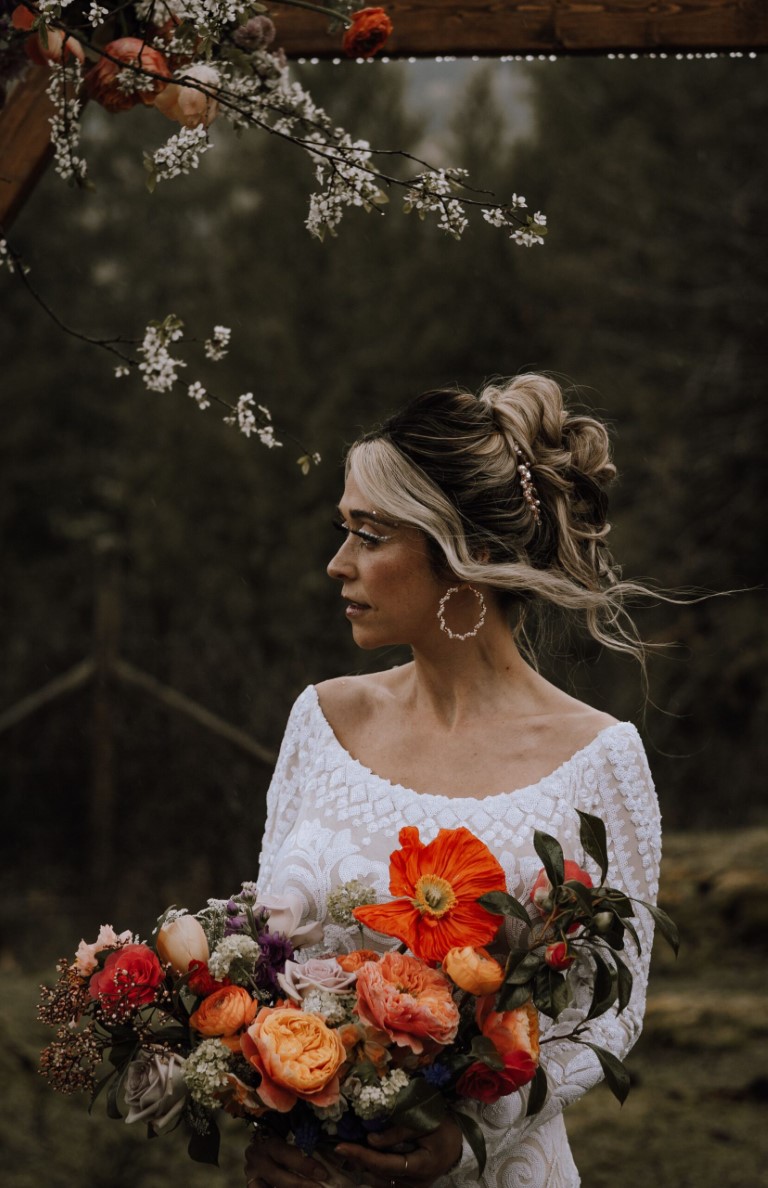 Bride carries orange and yellow bouquet on Vancouver Island