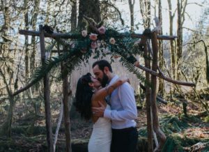 Newlyweds at Cermony Arch by Elyse Anna Photography West Coast Weddings Magazine