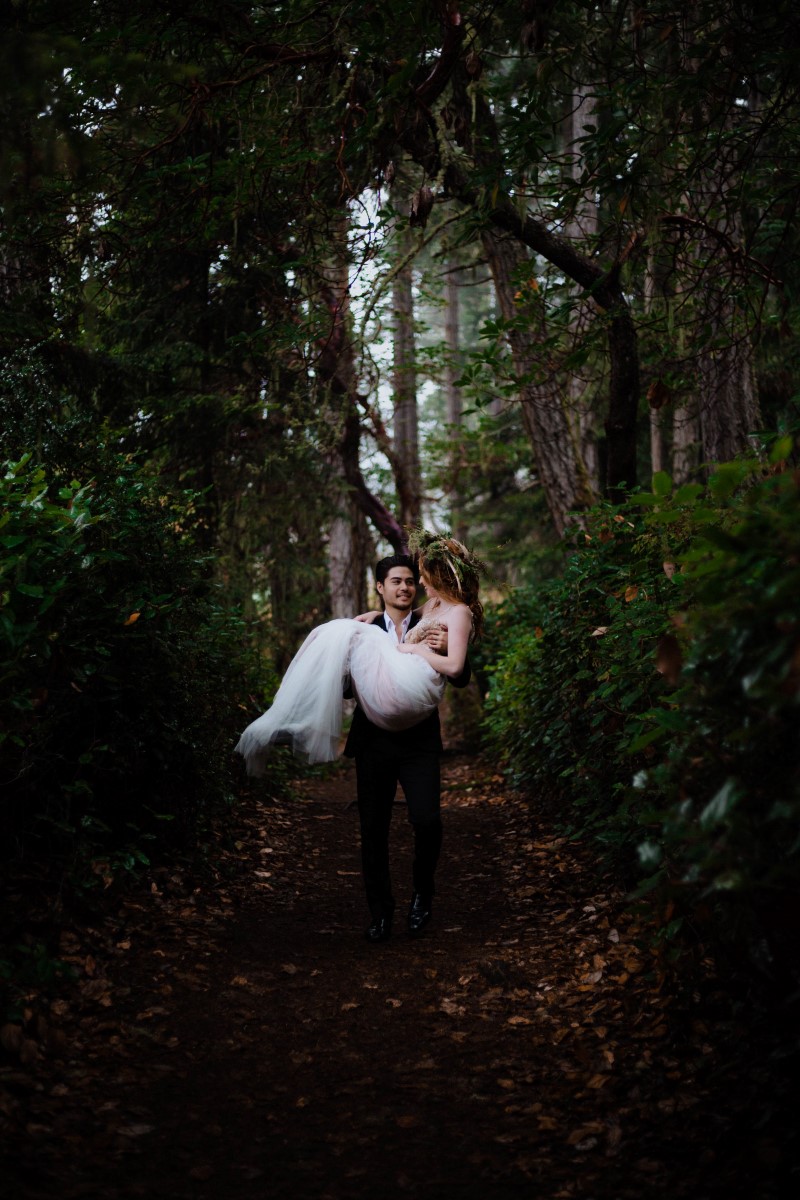 Celtic Bride carried by Groom on Forest Path by Megan Maundrell Vancouver Island Wedding Magazine