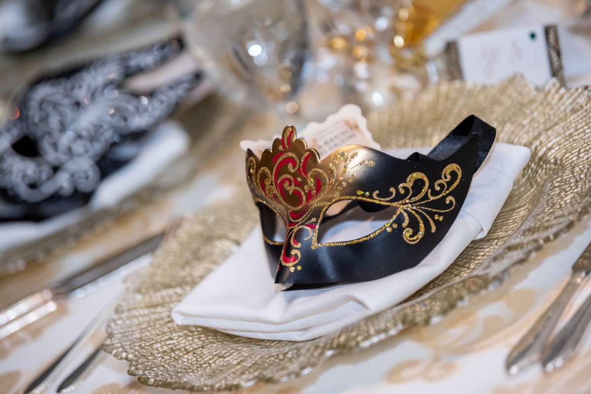 Venetian elegance mask giveaway on wedding reception tables at Vancouver Club