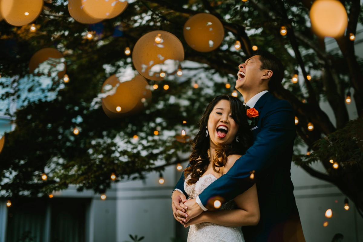 Chinese fusion wedding newlyweds laugh together