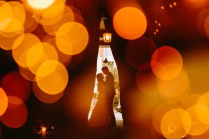 Newlywed couple surrounded by lights