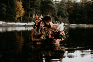 Couple in water with flowers on them