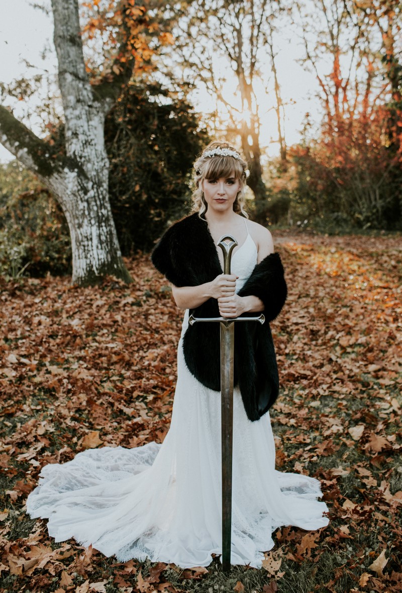 Bride holds sword in Game of Thrones Inspired Shoot