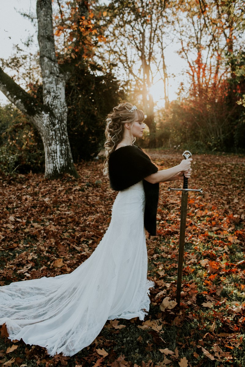Game of Thrones Inspired Bride holds sword in the sunset