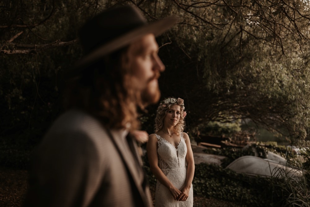 Golden Hour Sunshine Coast elopement focus on bride wearing Martina Liana Gown at Bisou bridal groom blurry out of focus staring off