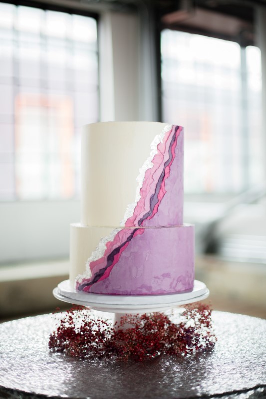 Purple and white Wedding Cake in front of windows by Taffete Designs Vancouver