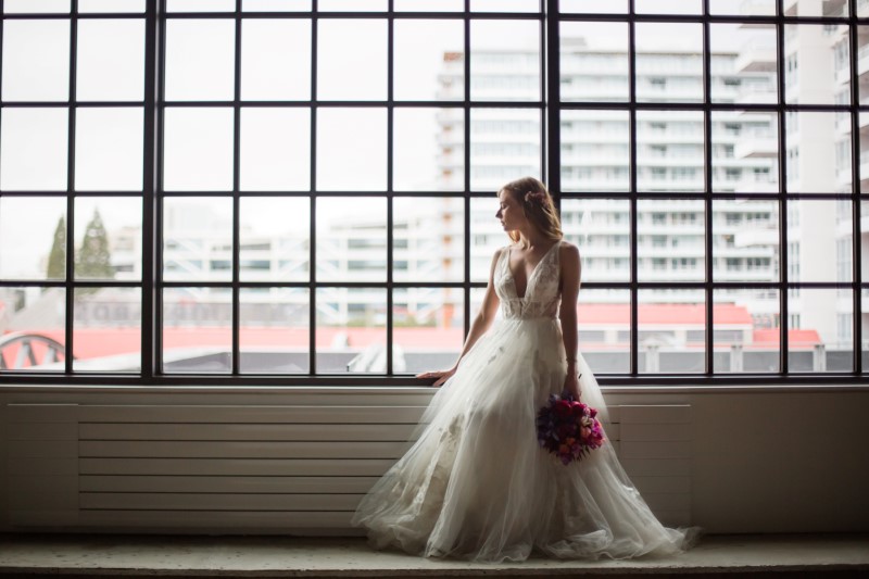 Vancouver Wedding Bride looks out window over the city
