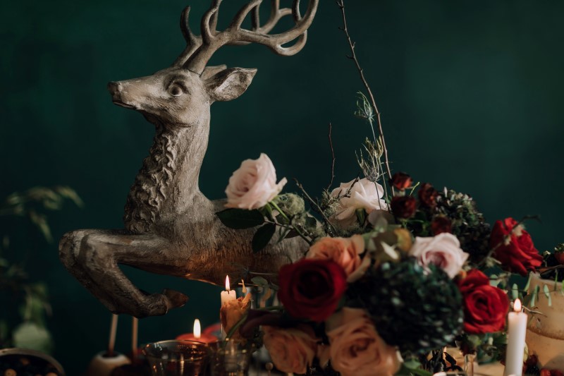Culture Fusion reindeer statue with candles and flower arrangements