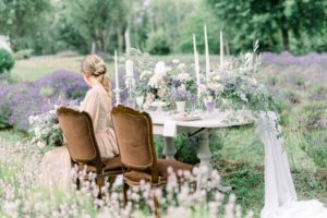 Bride seated at floral table in field of lavender in Vancouver