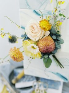 Yellow Roses and Orange and Blue Flowers on Dusty Blue Cake by Niki Xie Photography