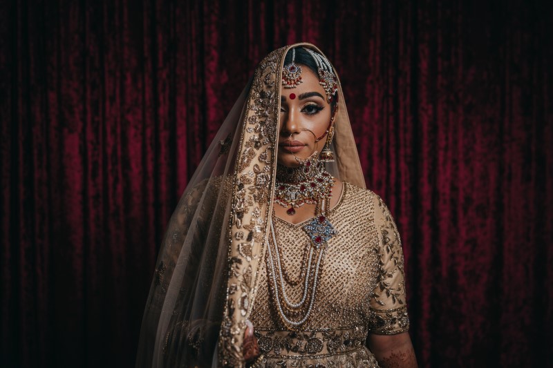 Indian Bride hides half her face behind luxurious veil by Dreamfinity Studios