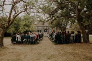 Charming Farm Wedding Ceremony Outdoors by Wood House at Bilston Creek Farm on Vancouver Island