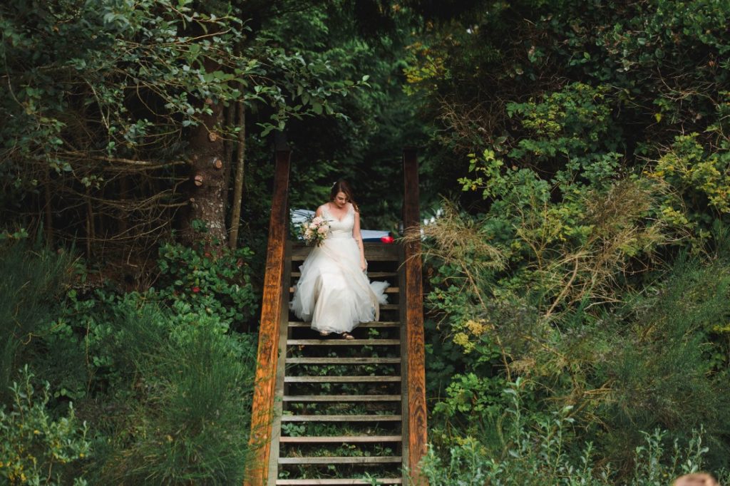 Ocean Wedding Bride walks down stairs to the beach ceremony