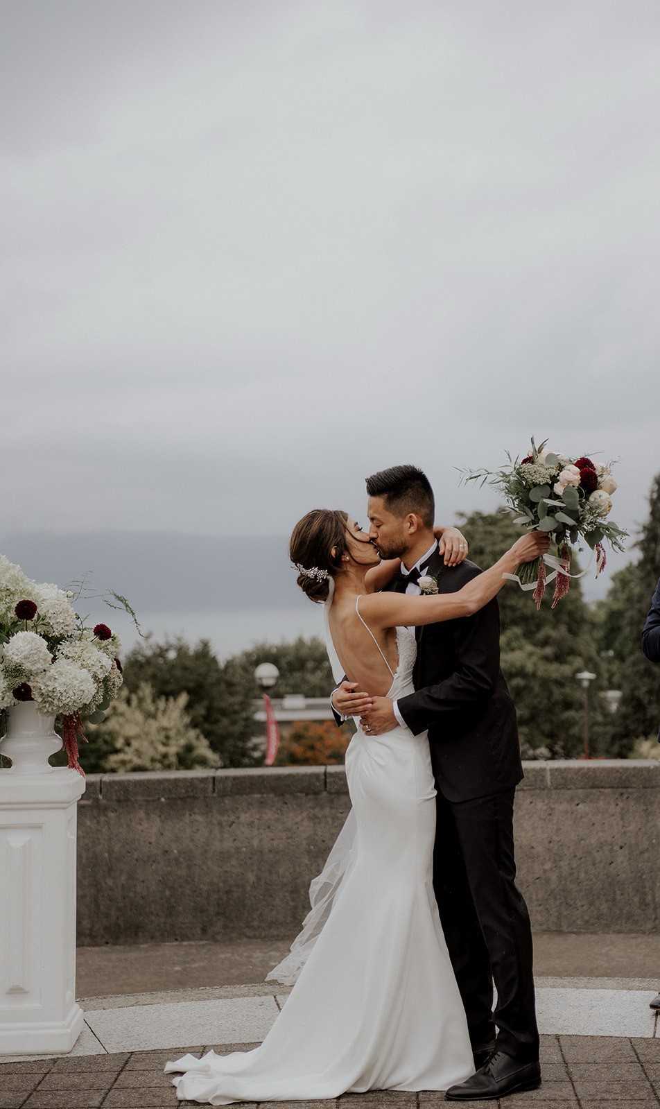 Newlyweds ceremony kiss at UBC Rose Garden wedding by Elle Weddings 