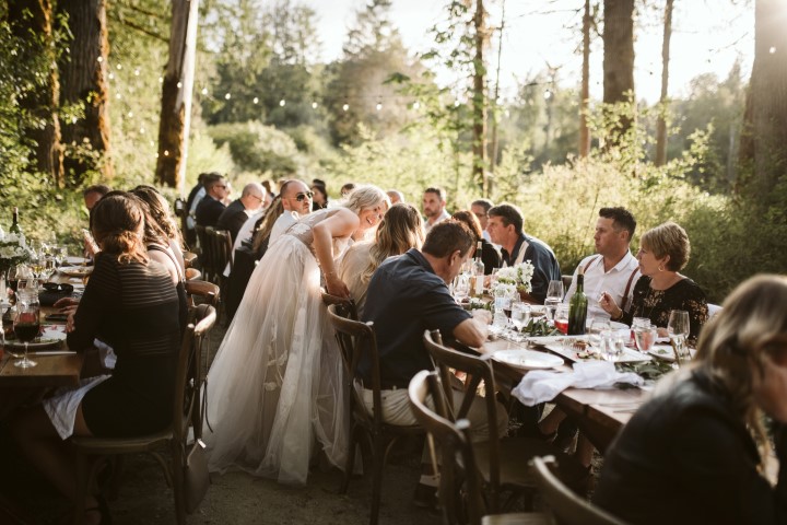 A Forest Wedding Vision Artfully Catered guests seated at long tables in the forest on Vancouver Island