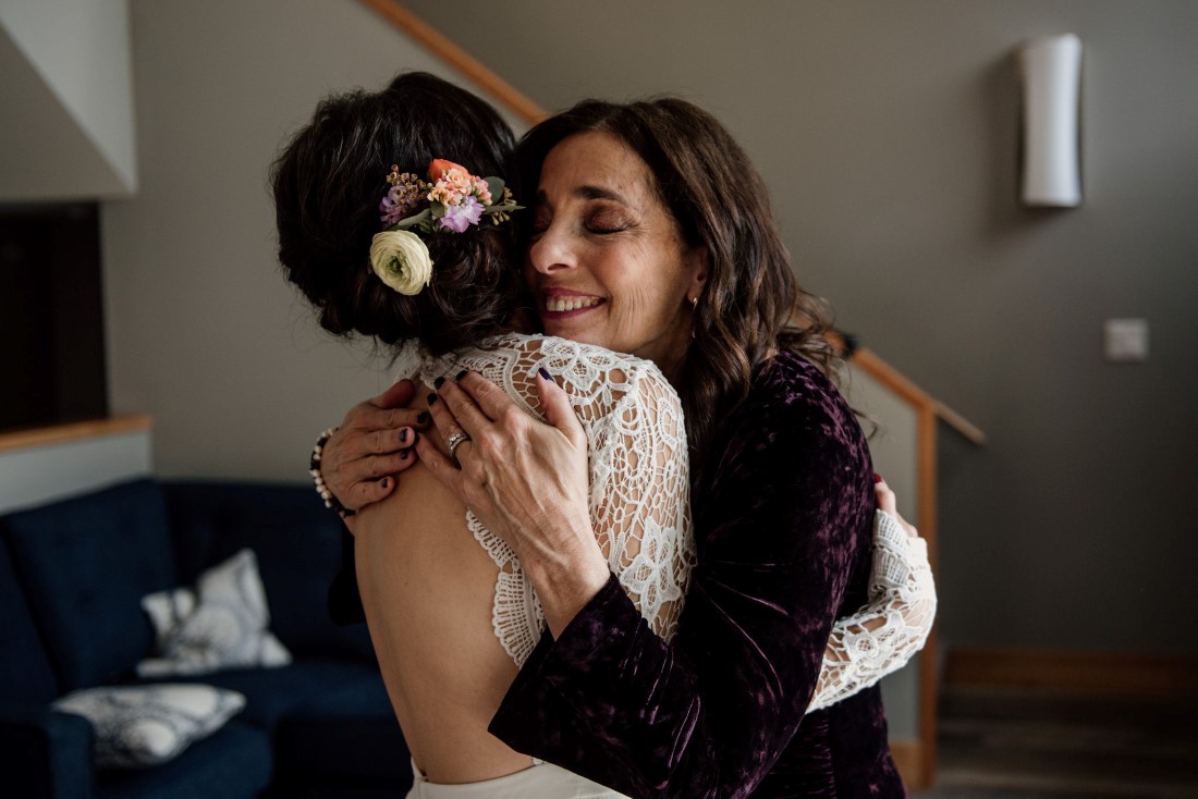 Mother hugs her daughter the bride 