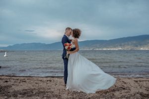Newlyweds kiss in front of Okanagan Lake