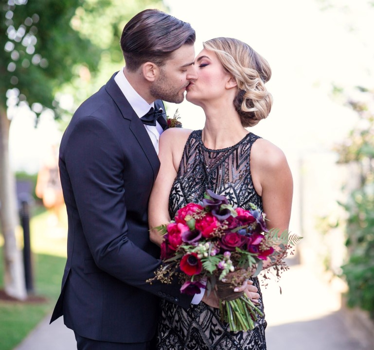 Romantic Black Lace Wedding Gown as bride kisses groom by Joanna Moss