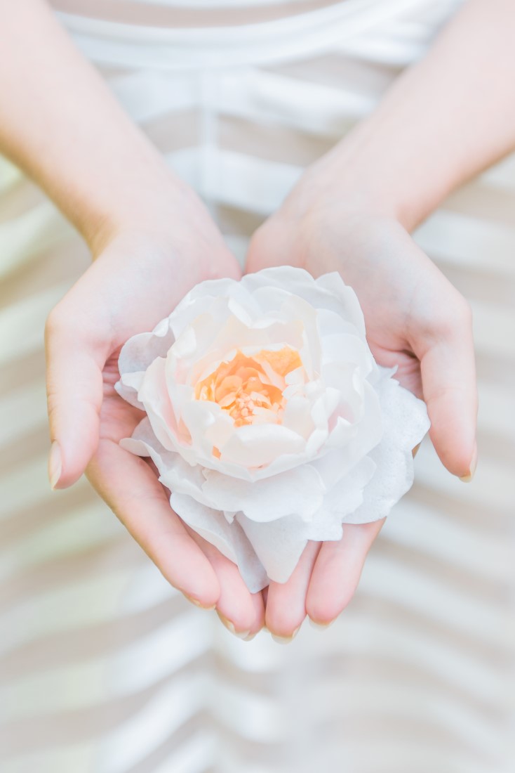 Garden of Eden Wedding Inspiration bride holds white peony in her hand