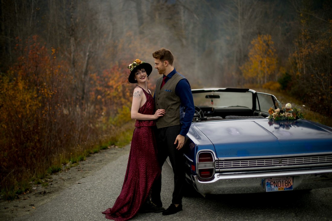 Road Trip Elopement Couple lean against blue classic car near Whistler Vancouver