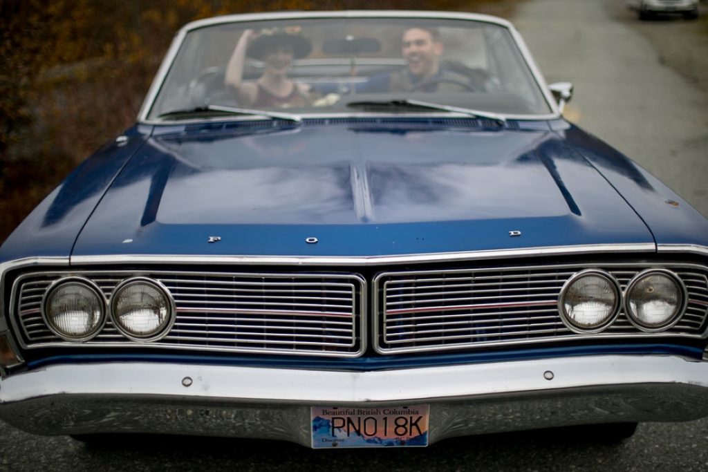 Newlyweds in classic blue car by Meghan Andrews Photography