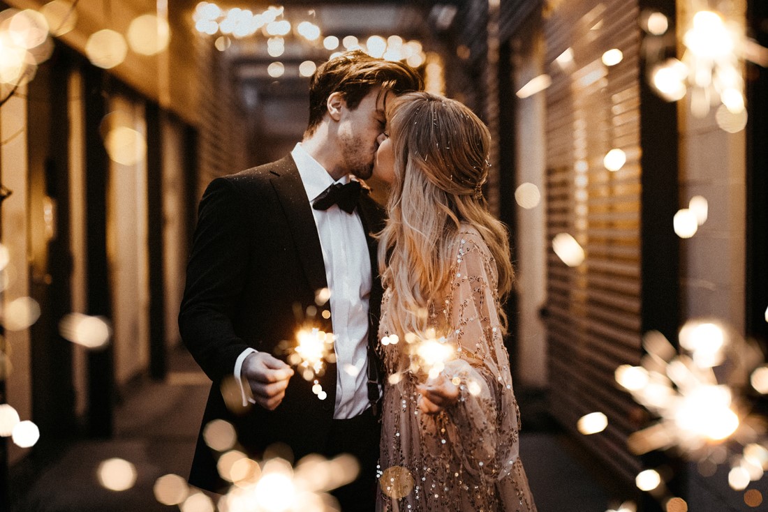 Romance & Champagne Kisses couple in alley with sparklers 