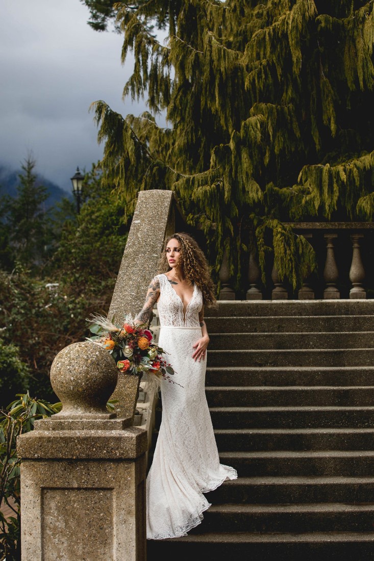 Bohemiian Inspired Elopement bride stands on the stairs of Swaneset Vancouver