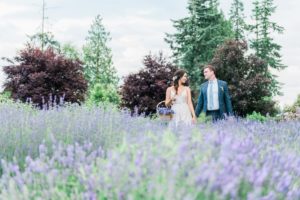 Bride and groom walk through field of lavender by Lestelle Photography