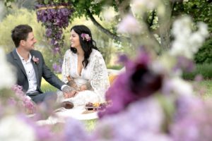 Purple Lilac Spring Wedding Hattie Root Photo Couple share picnic in garden