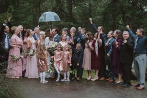 Sophisticated Gallery Kacie McColm Photography kissing under umbrella with wedding party