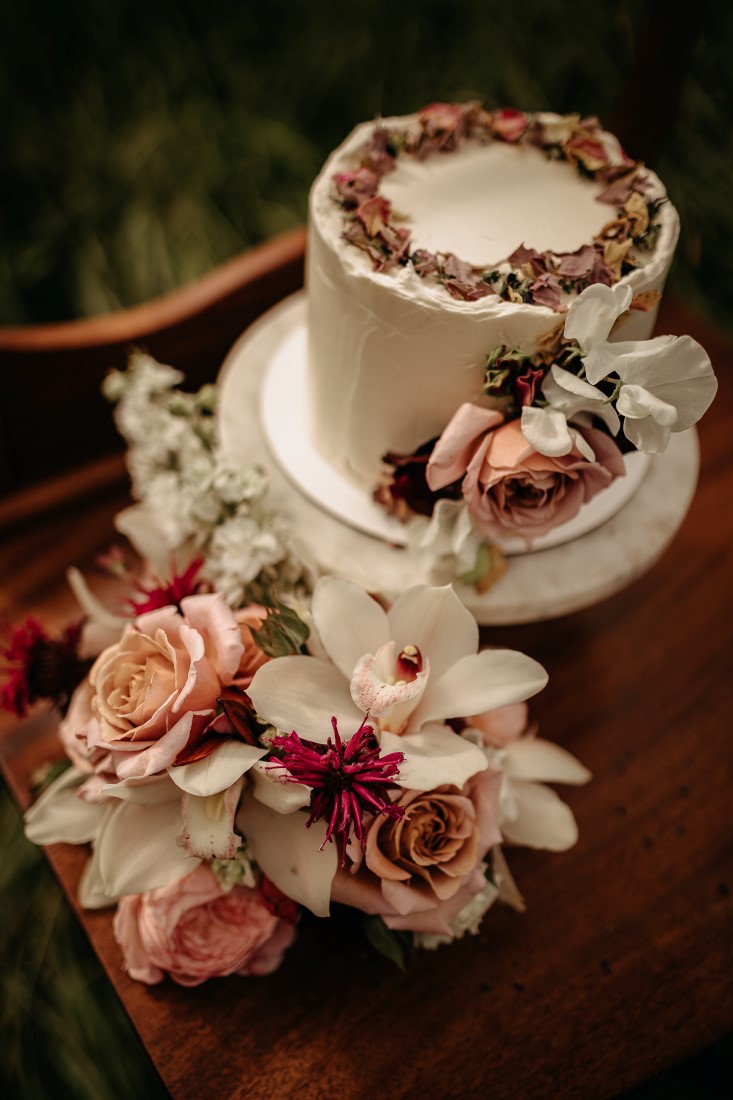 White wedding cake with pressed flowers on vintage dresser by Schur to Please Vancouver Island