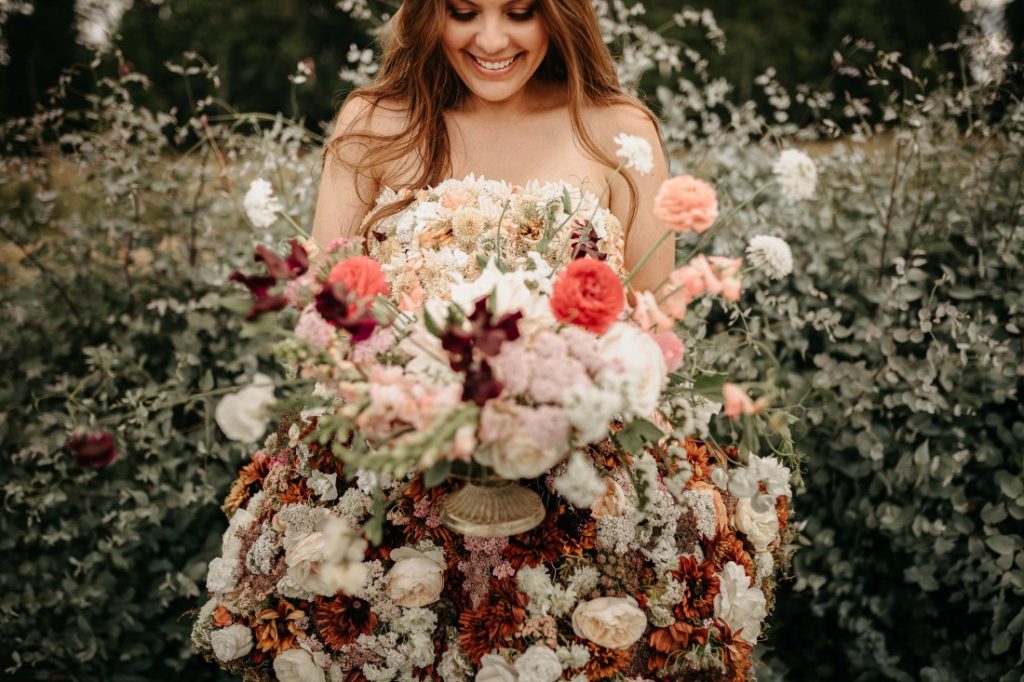 Dandelion Farm bride holds lush wedding bouquet