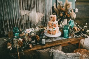 Wedding Cake on wooden table with bohemia floral