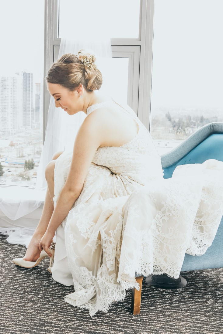 Elka The Makeup Artist Photography Bride putting on shoes Bridal Grace and Style High Above Vancouver