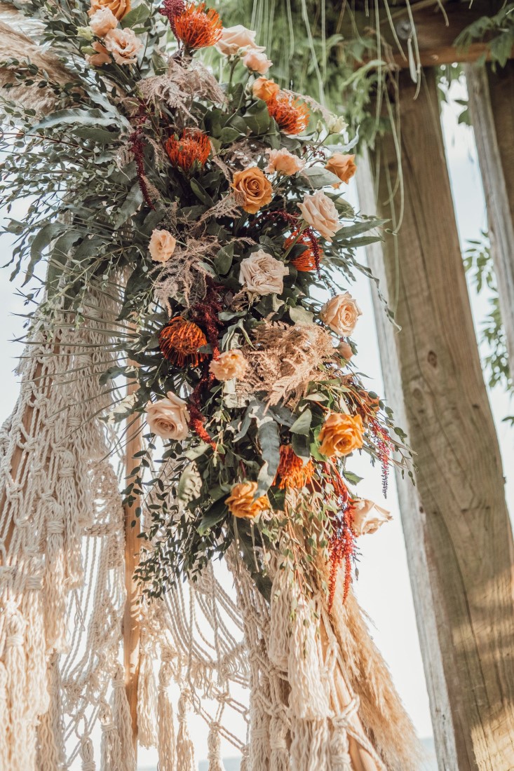 Cascading floral bouquet of peach roses and ruskus