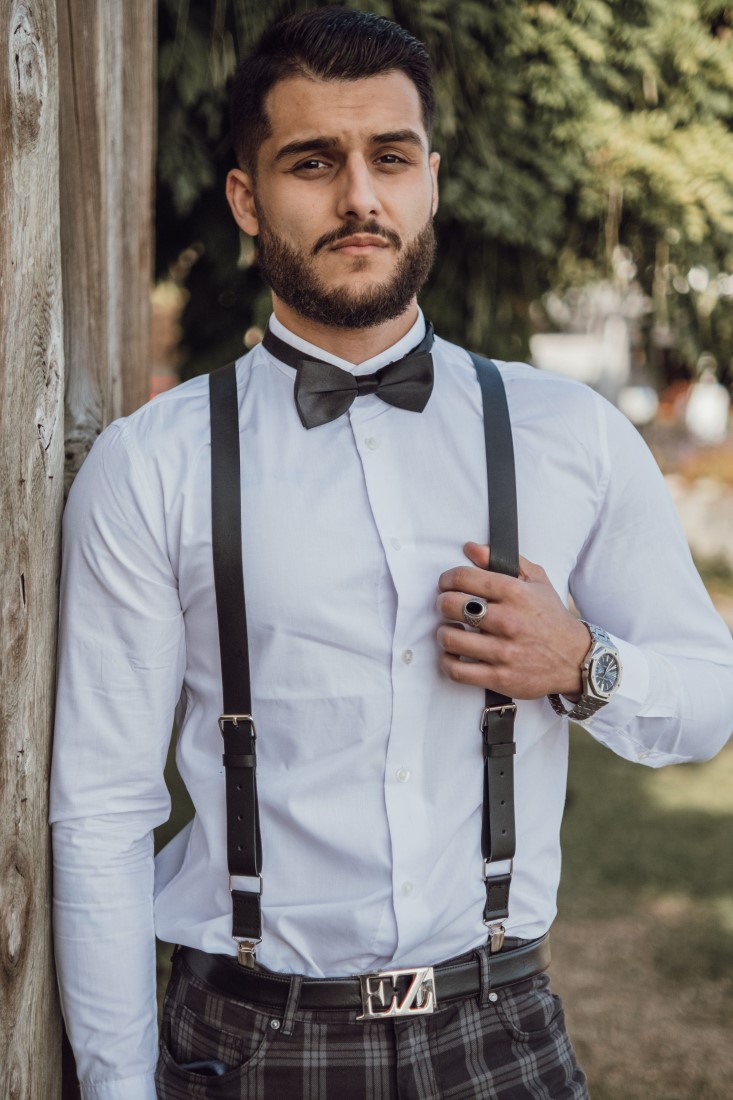 Groom in suspenders and bowtie