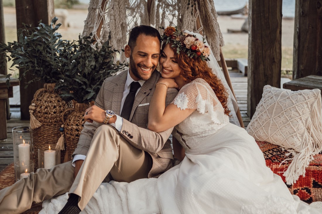 Bride and groom and boho teepee