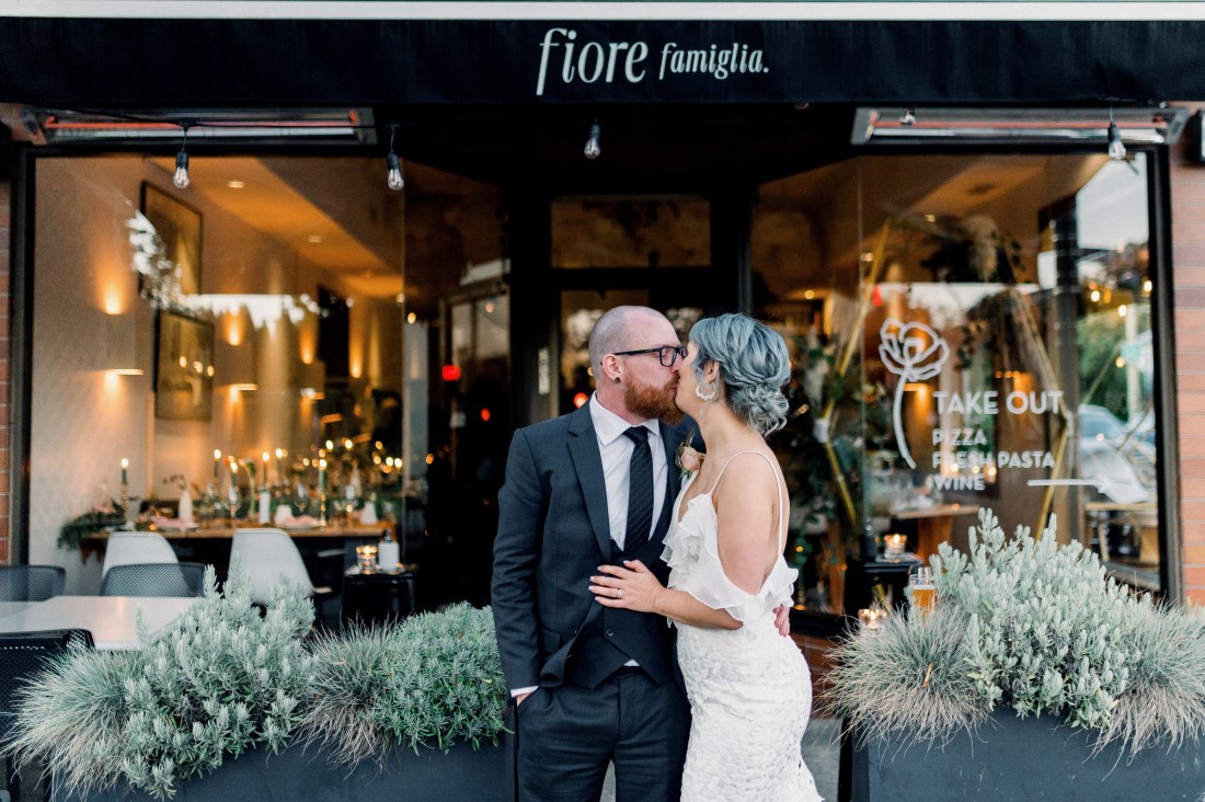 Downtown Devotion Newlyweds exchange a kiss in front of Vancouver bistro