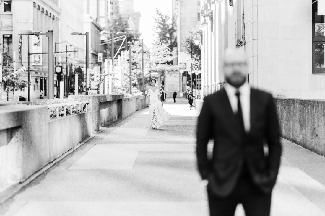 Bride walks towards groom for first look on Vancouver street