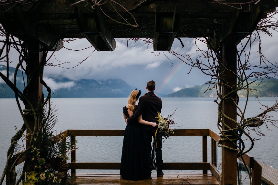 Extraordinary and Unique Wedding Couple look out at Harrison Lake