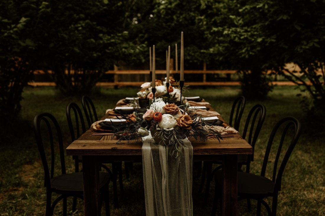 Long farm table in forest with taper candles and wedding decor by Trend Decor Vancouver Island