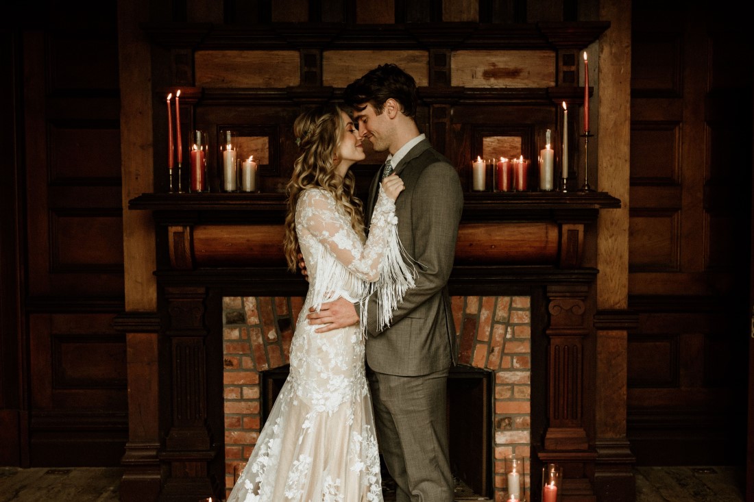 Rustic Romance Newlyweds in front of fireplace at Keating Farm Vancouver Island