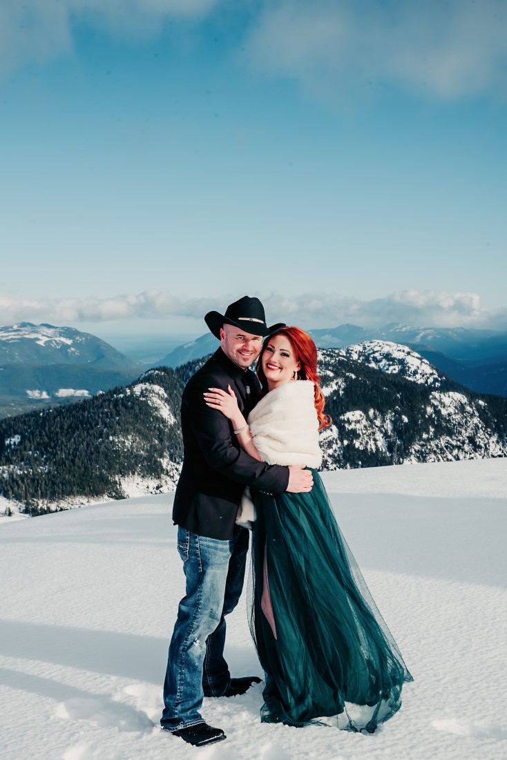 Engaged Couple wearing green gown and black cowboy hat on Vancouver Island