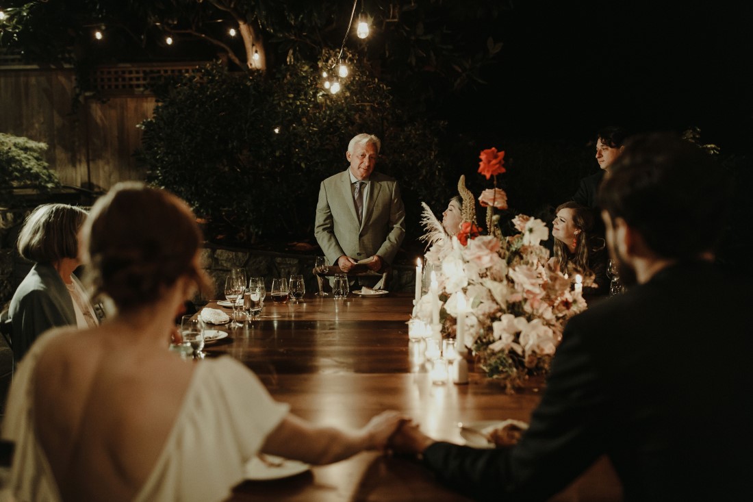 Father stands at Vancouver reception table and gives speech to newlyweds