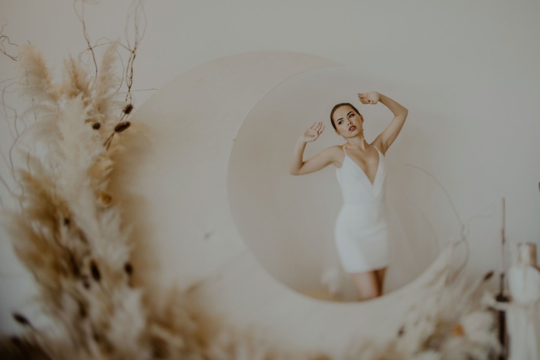 Bride behind large moon and pampas grass decor