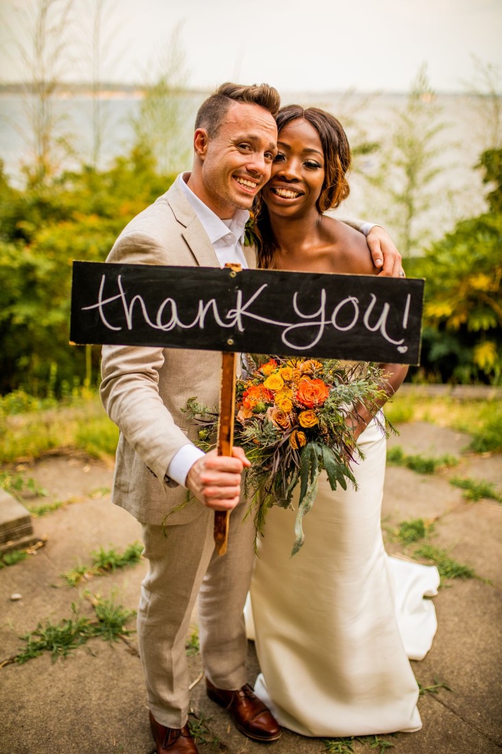 Newlyweds hold thank you sign by Esther Moerman