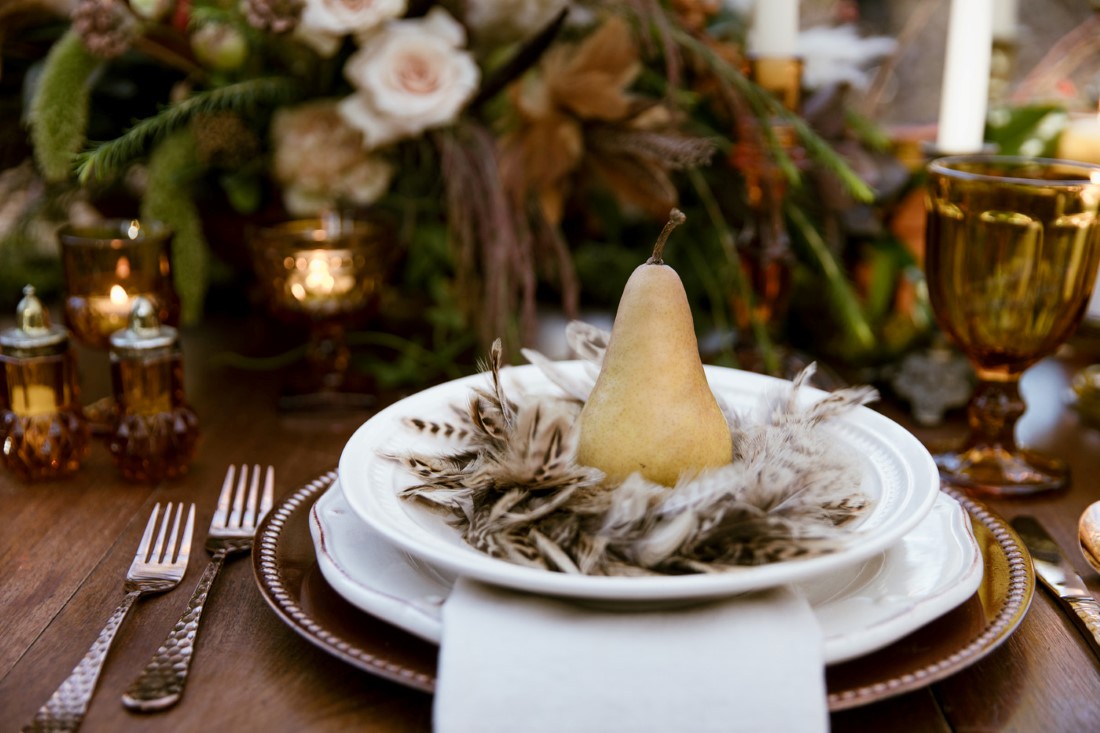 Pear sits in feathers on wedding table